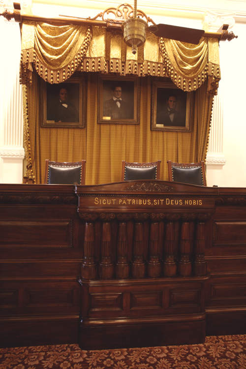 Original Supreme Court judges' bench. The Latin phrase reads, "As to our fathers, may God be to us."