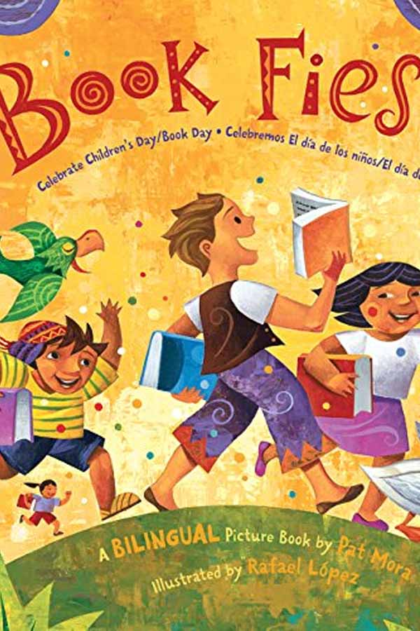 Cover of children's book, "Book Fiesta," three children running over a hill carrying books