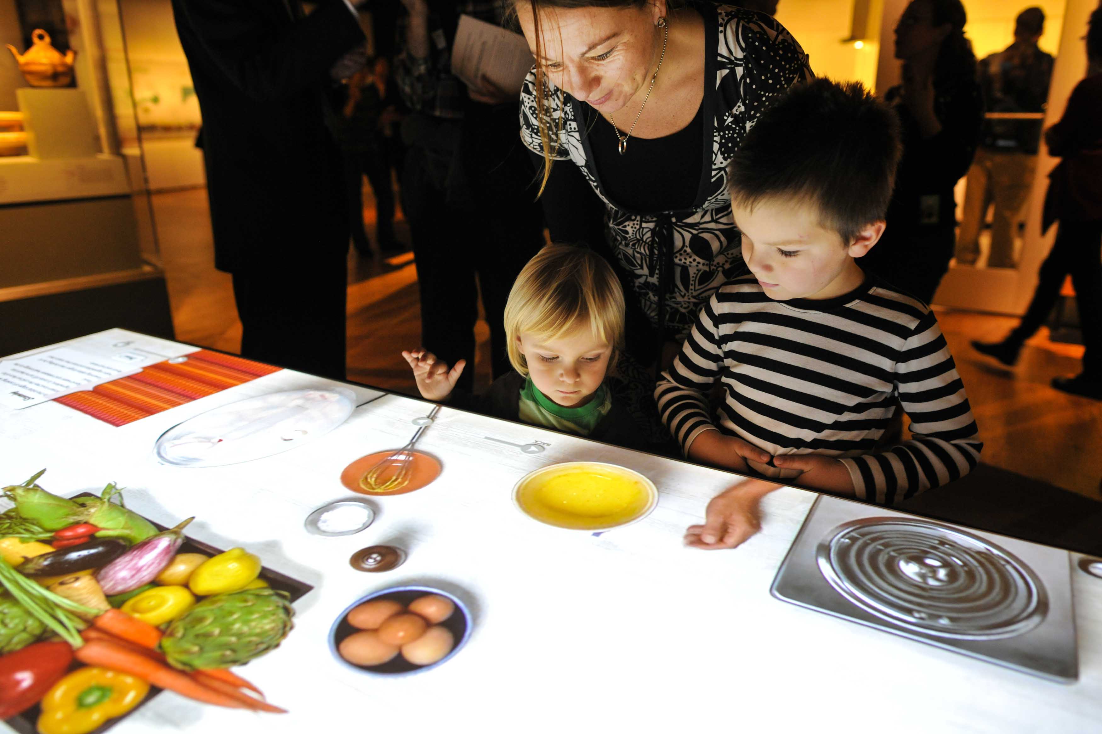 Visitors may take a turn at an interactive cooking table to 'make' virtual dishes eaten around the world. The exhibition open will be in Austin from March 12 to July 24, 2016.