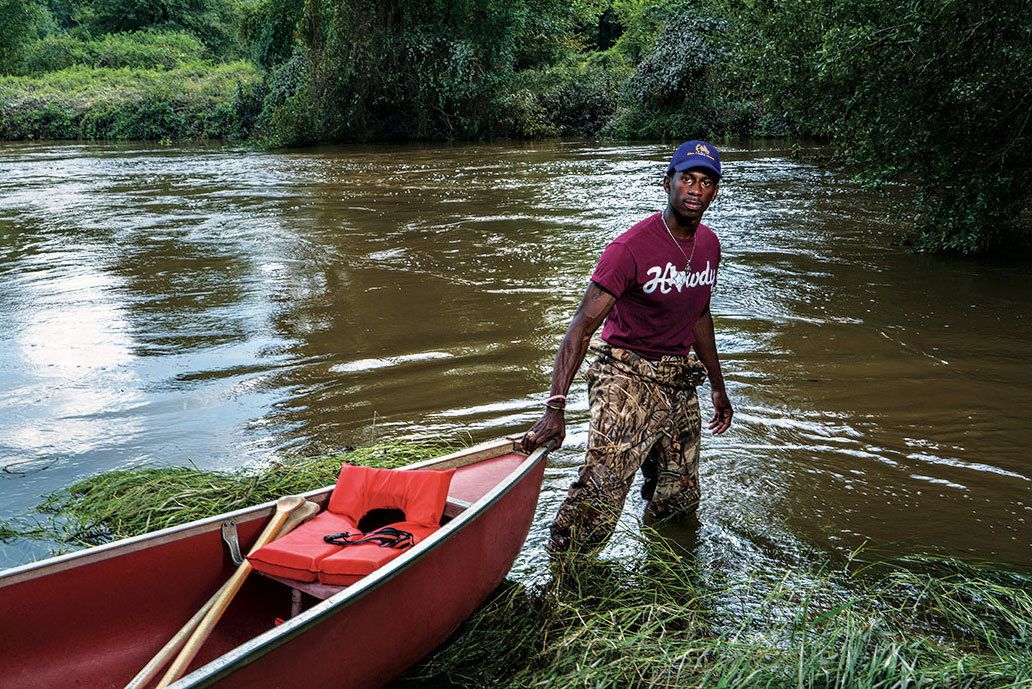 Tyree Finley, whose story is featured in the exhibition, assists with flood rescue efforts. Courtesy of Darren Braun.