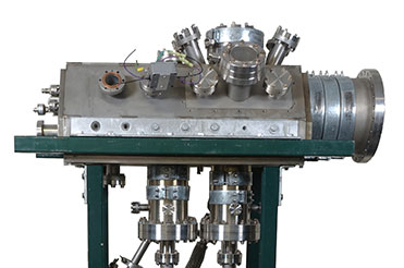 Cylindrical titanium workstation machine with protruding pipes and controls