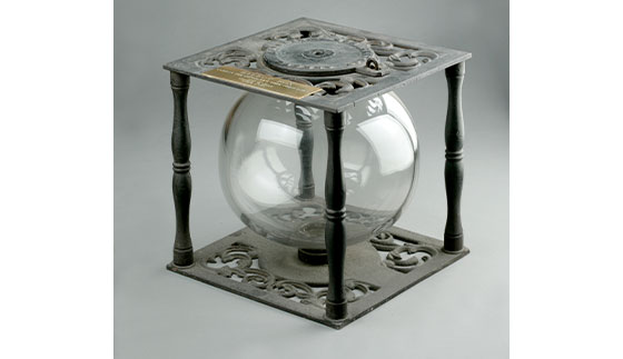 1857 ballot box, a clear glass orb inside of a metal ornate casing
