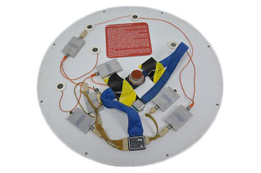 various wires and sensors connected to a white circular piece