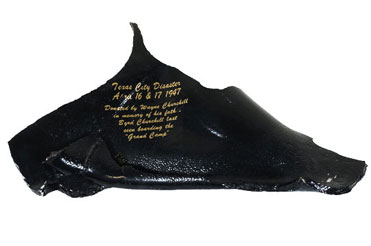 black, charred, shiny piece of shrapnel from a ship in the Texas City Explosion