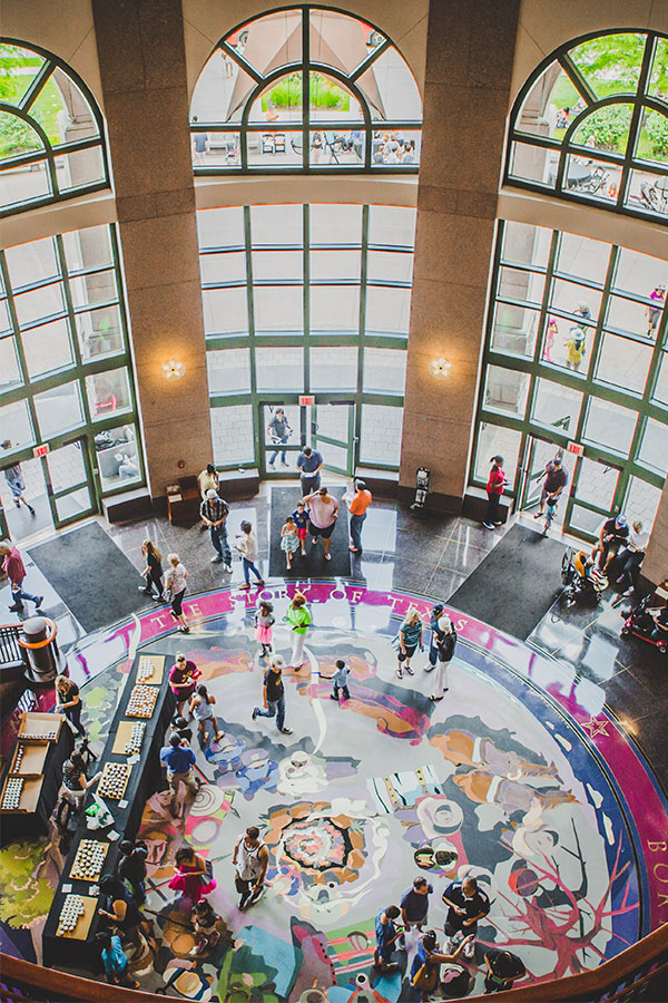 Visitors in museum lobby secondary image