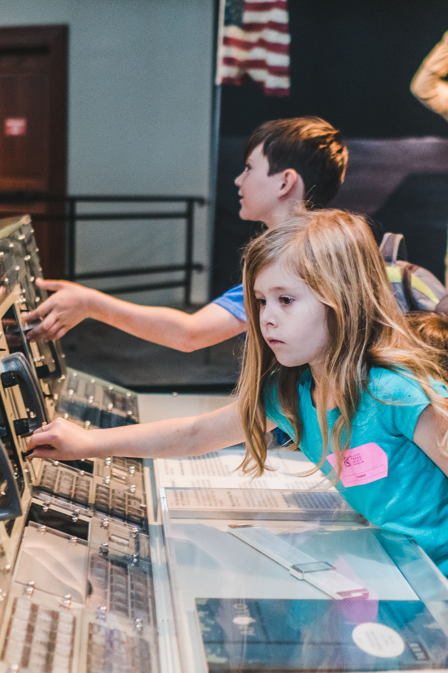 Young girl interacting with mission control model