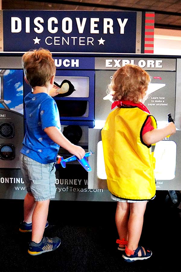 Two children interacting with space exhibit