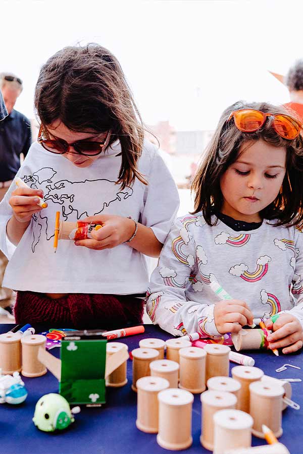 two children wearing sunglasses doing a craft at the Bullock Museum