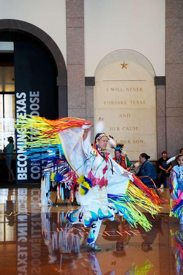 woman dancing in colorful traditional American Indian outfit at American Indian Heritage Day at the Bullock Museum