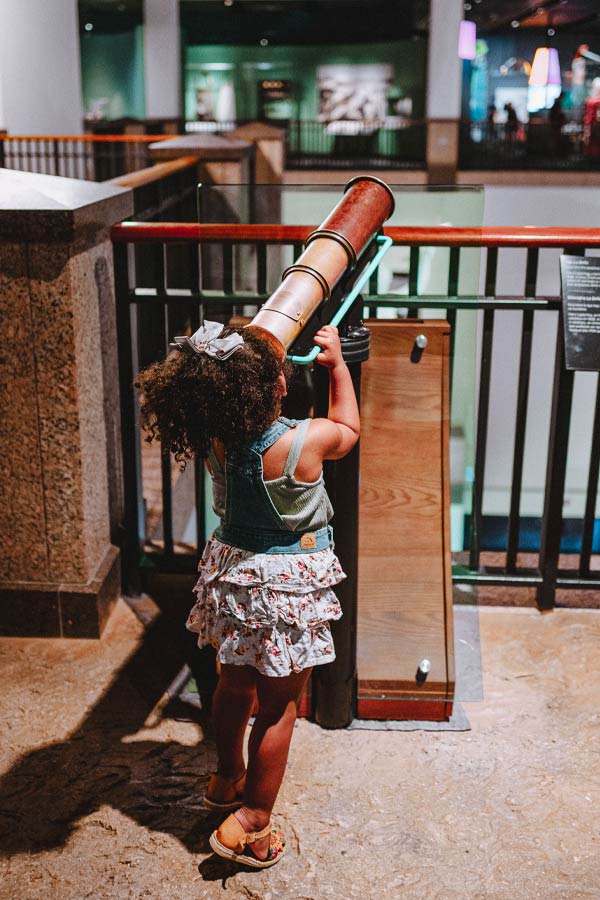 a child looking through an interactive spyglass at the Bullock Museum.