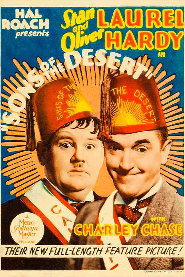 vintage movie poster of two men wearing red secret society hats, the man on the left looks surprised and the man on the right looks smug
