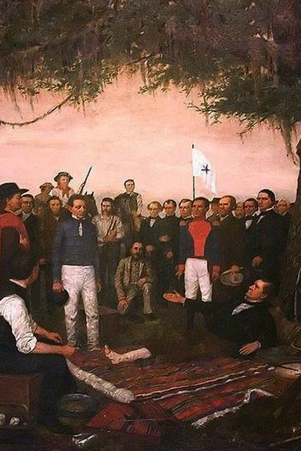An oil painting of the surrender of Santa Anna. It depicts Santa Anna with an injured leg and sitting on a blanket in front of a large group of military men.