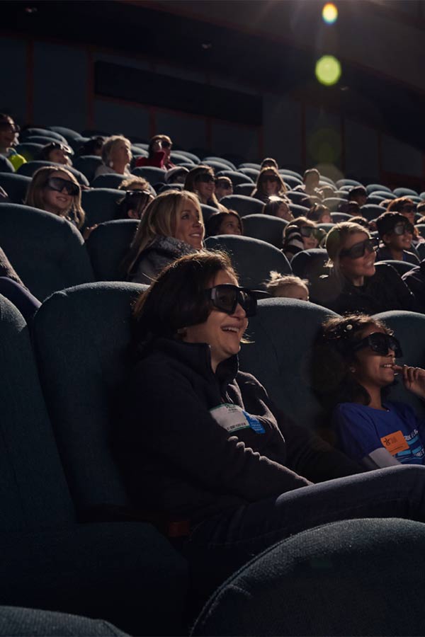 people sitting in a movie theater smiling