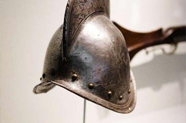 European metal helmet on display in a museum