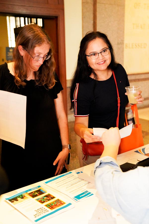 Two educators registering for a workshop at the Bullock Museum.