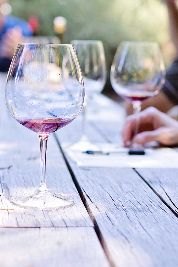 Three empty wine glasses on a wooden table