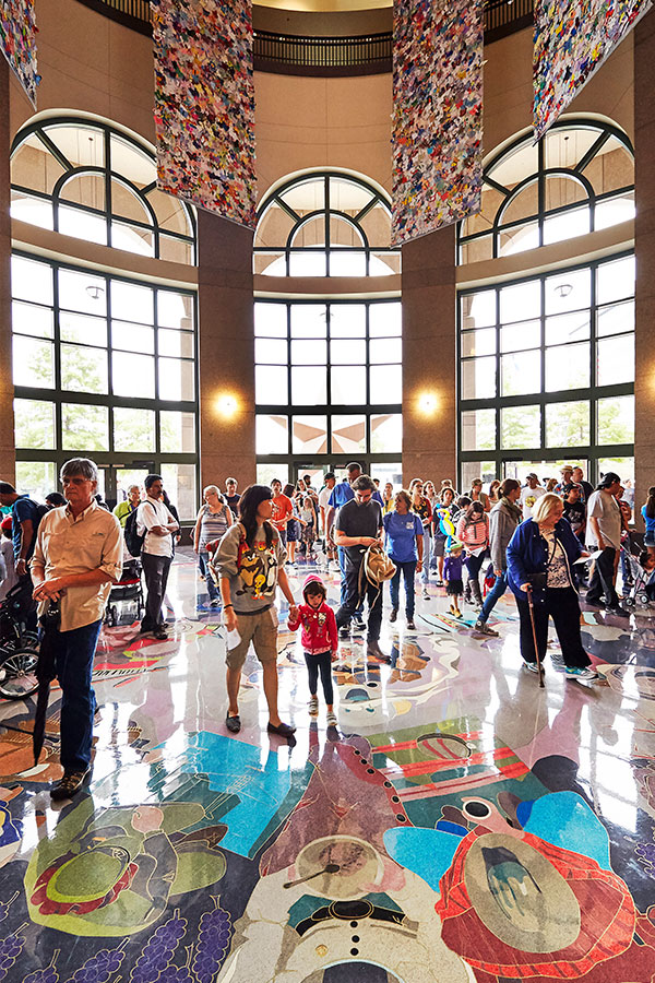 Visitors in museum lobby secondary image