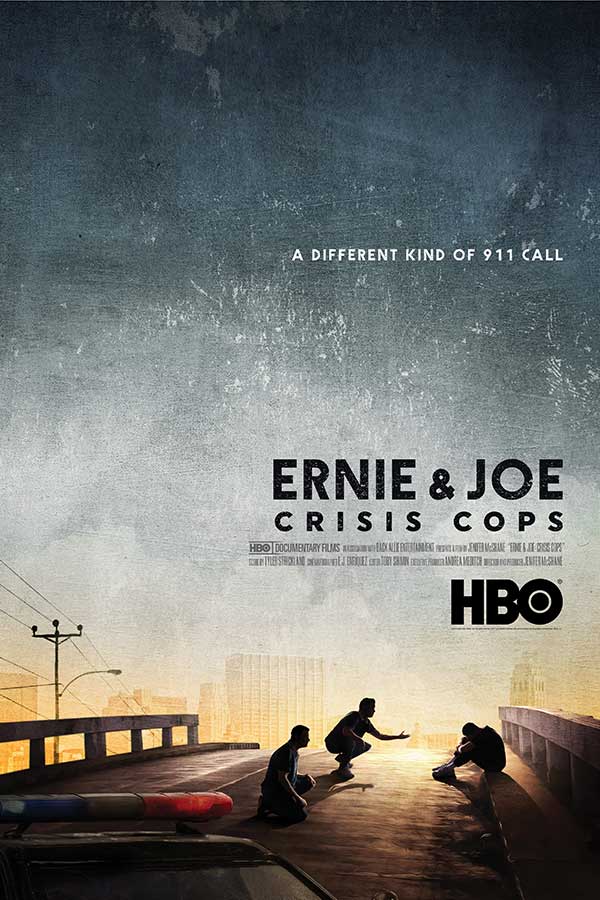 film poster for "Ernie and Joe Crisis Cops" with two cops kneeling on the ground in front of a person on the edge of a bridge