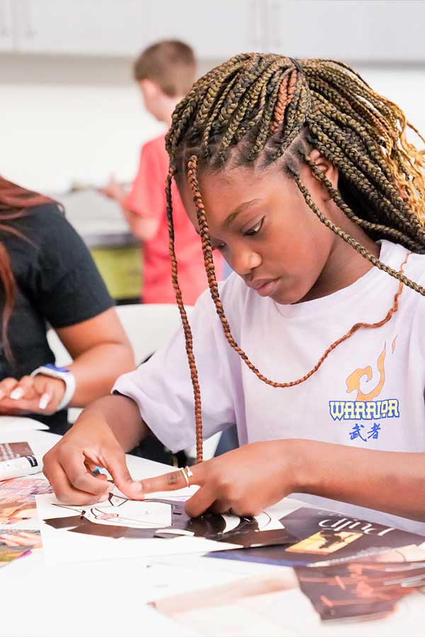 a teen concentrating on doing a craft at the Bullock Museum