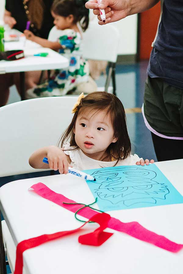 a young girl doing a coloring activity in the Bullock Museum