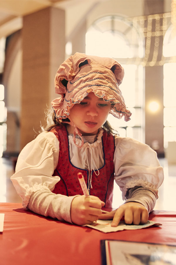 Girl in pioneer hat