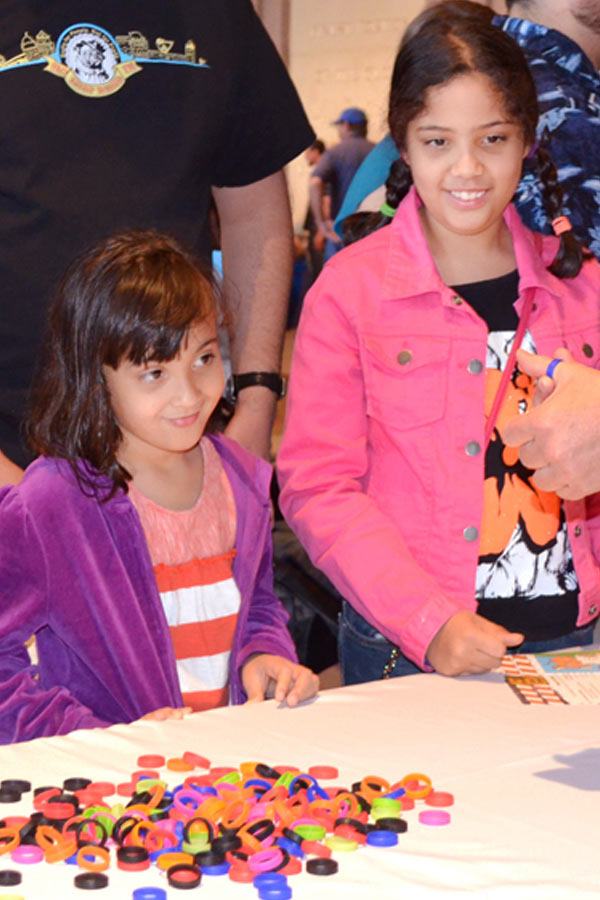 two girls listening to a craft demonstration