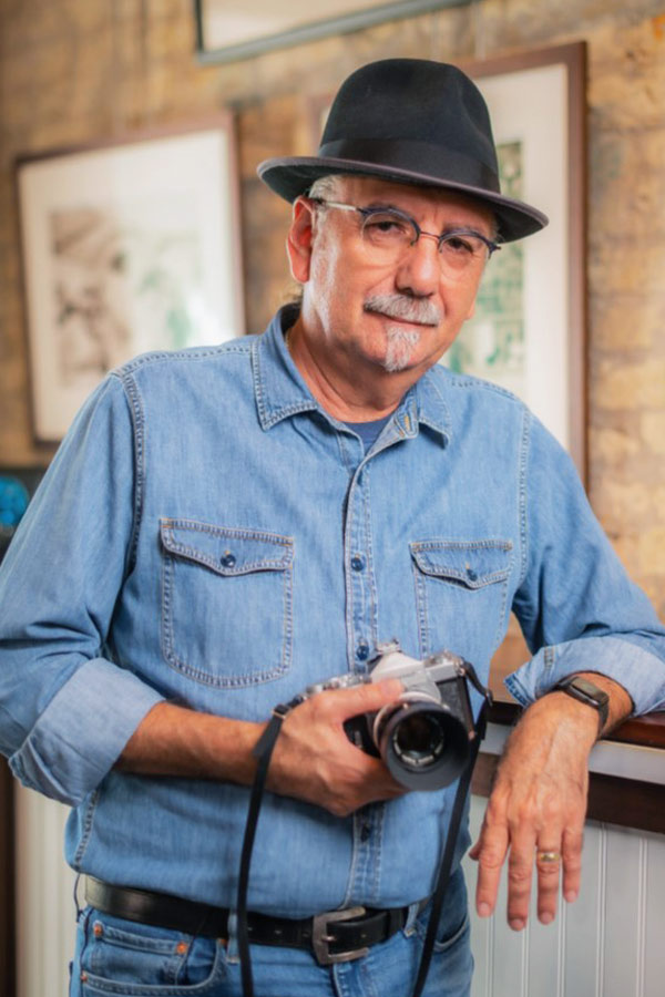 Al Rendon posing while holding a camera