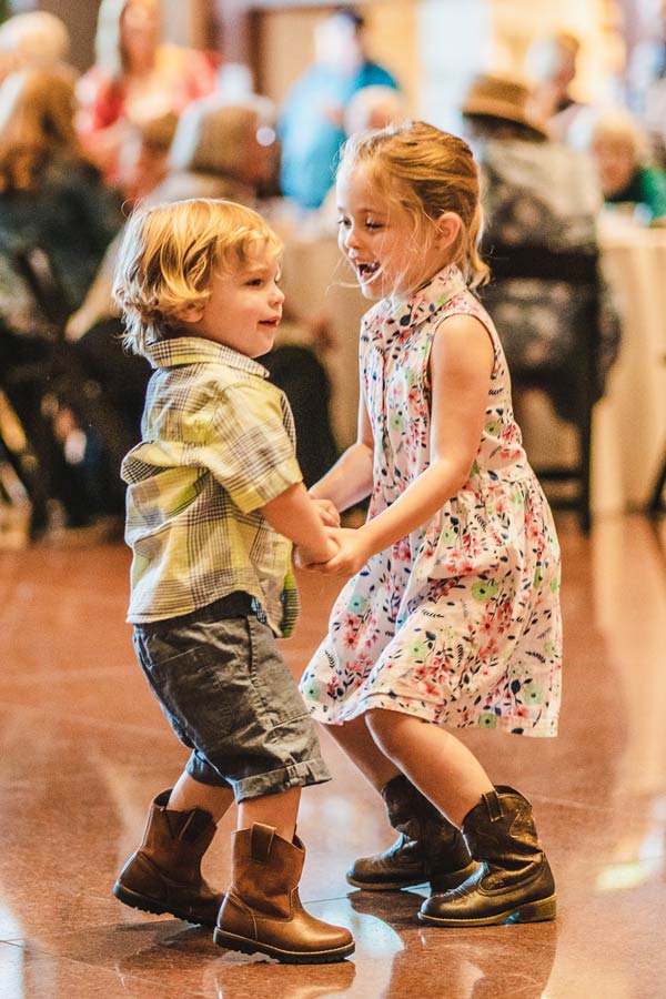 children dancing and wearing cowboy boots at the Bullock Museum