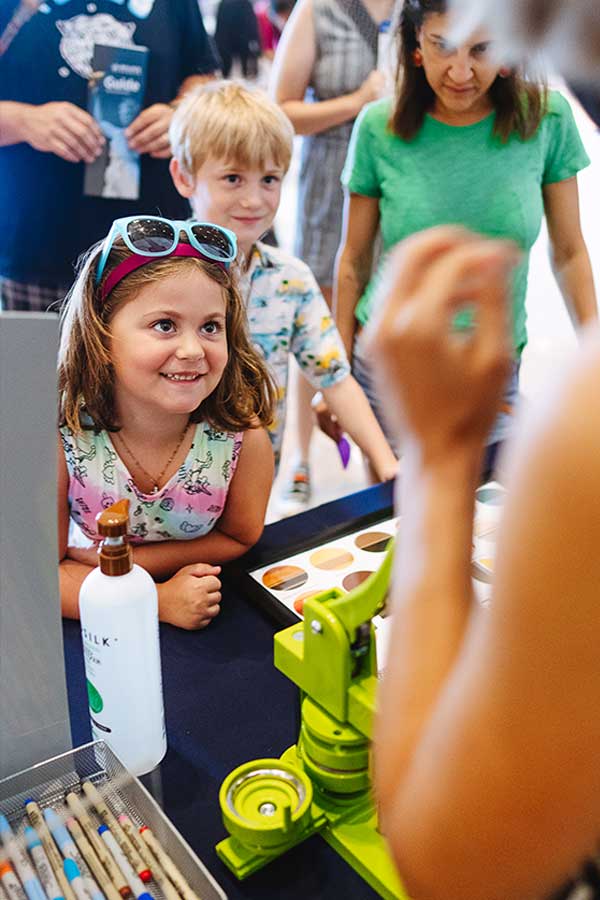 group of children looking at an adult standing near a table at the Bullock Museum