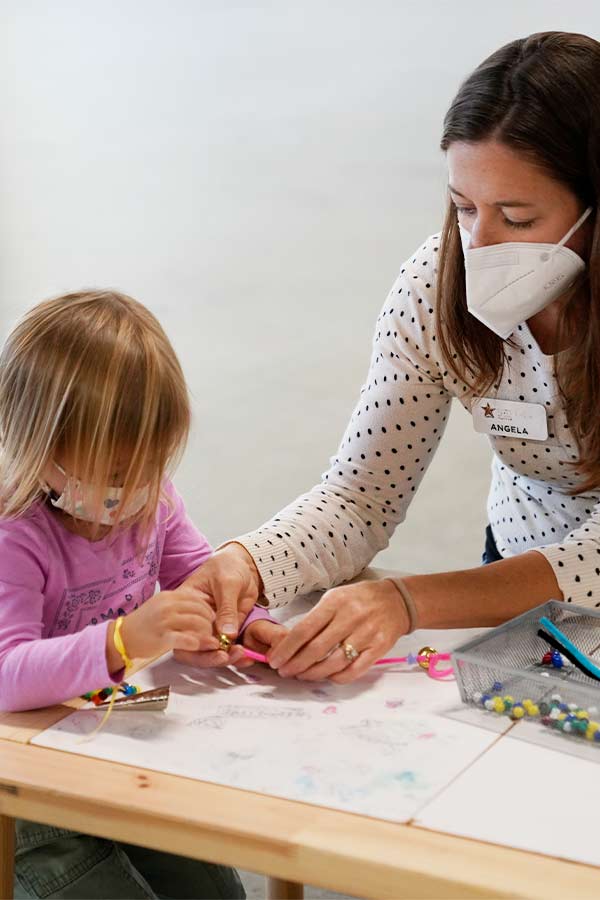 woman and child sitting at a table working on a craft in the Bullock Museum