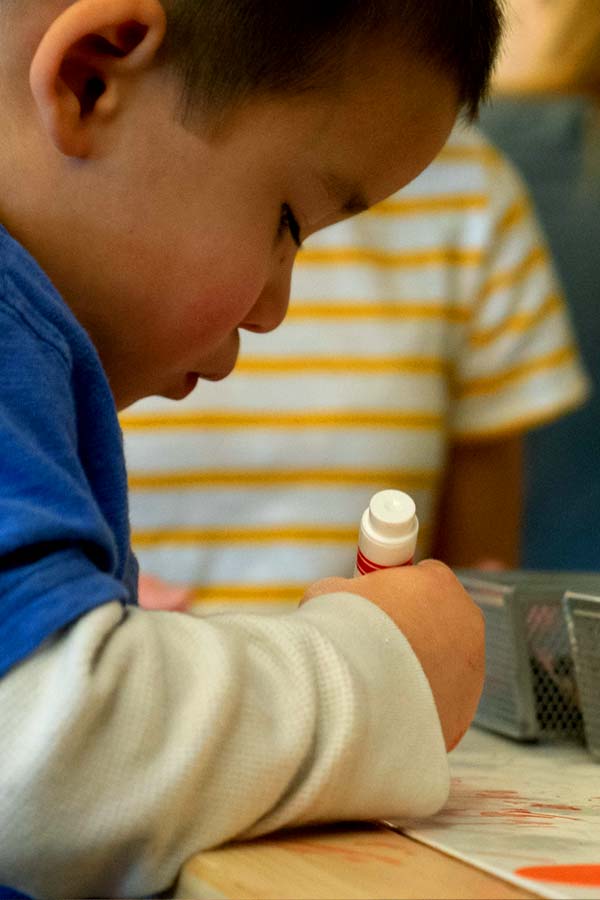 closeup of young child coloring at the Bullock Museum