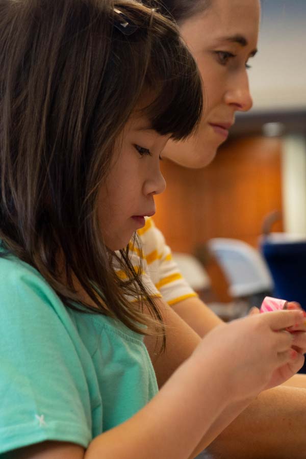 a young girl doing a craft activity