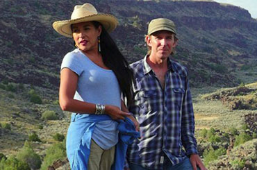 Man and woman on outlook, looking at vistas
