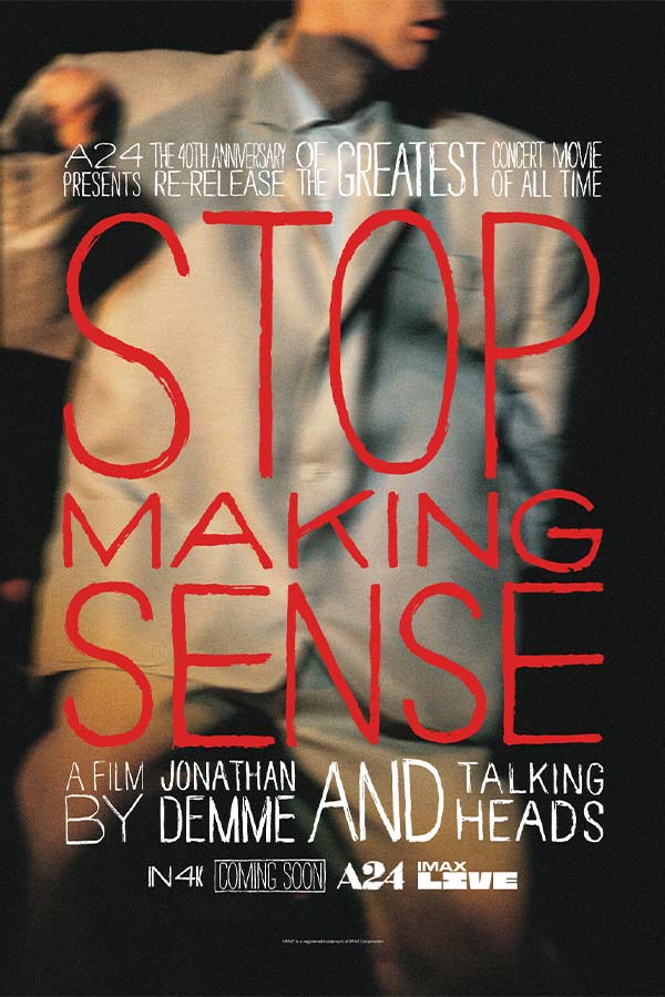 film poster for "Stop Making Sense" of a blurry image of a man in a large grey suit, red lettering on top reads "Stop Making Sense"