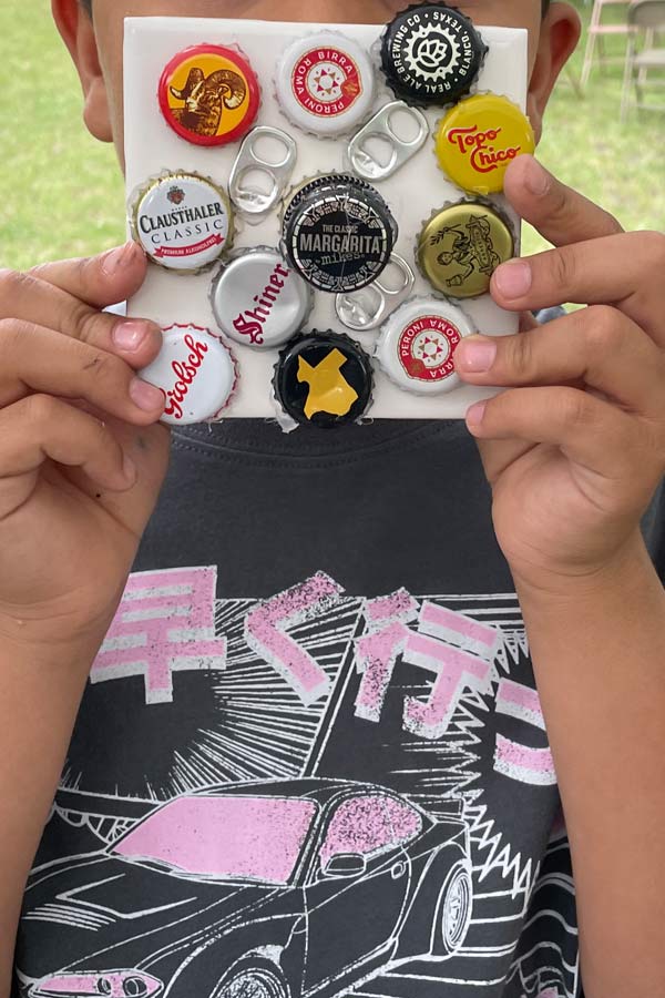 a person holding up a bottle tab project