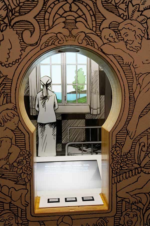 a screen set into a keyhole shaped cut out with an illustration of a woman looking out a window