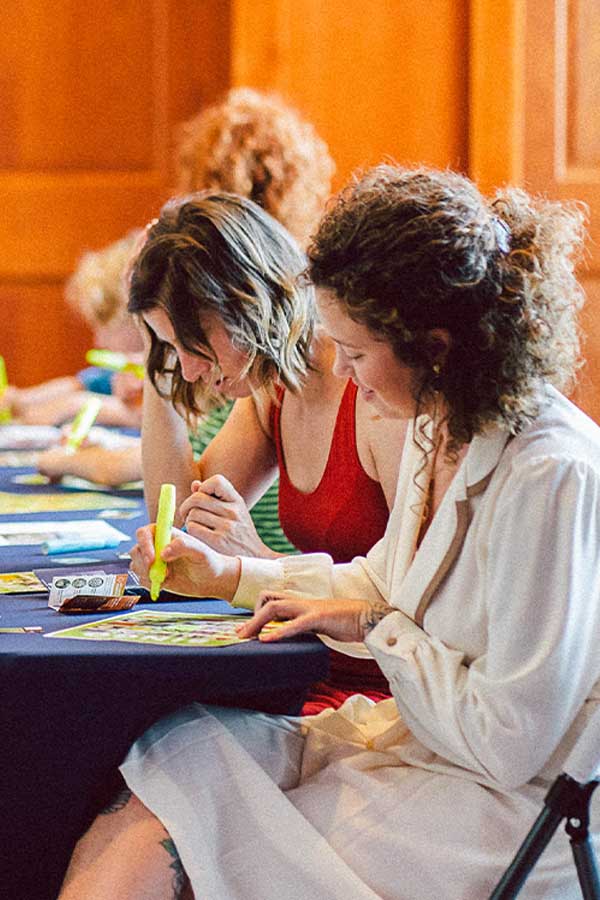 two adults sitting at a table highlighting a some paper in the Bullock Museum