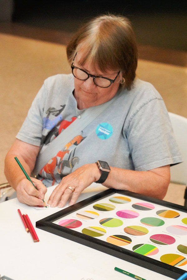 A person doing a craft at the Bullock Museum.