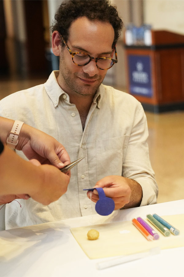 A person doing a craft at the Bullock Museum.