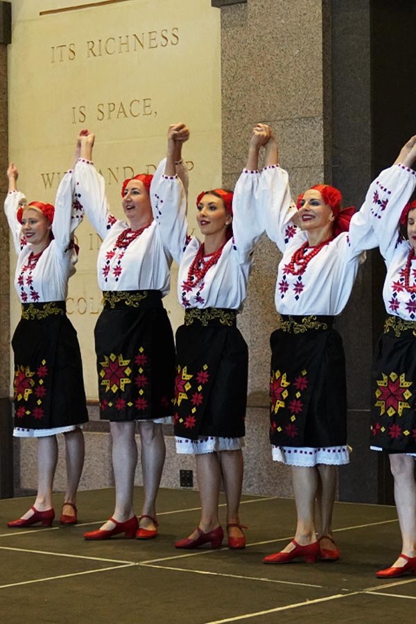 Women dancing in traditional regalia at the Bullock Museum.
