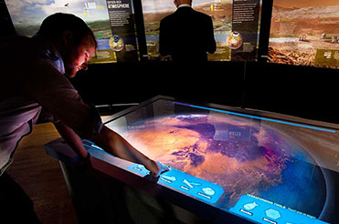 A man explores Mars on a touchscreen