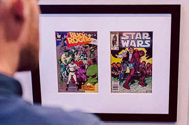 A man looks at comic book covers