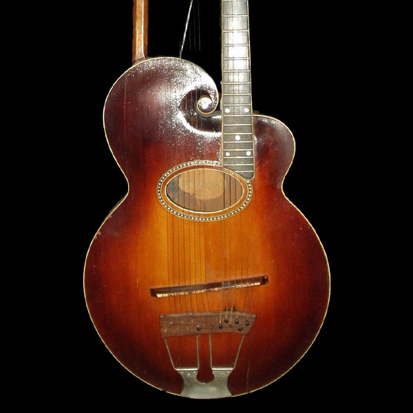 Brown Gibson guitar on a black background