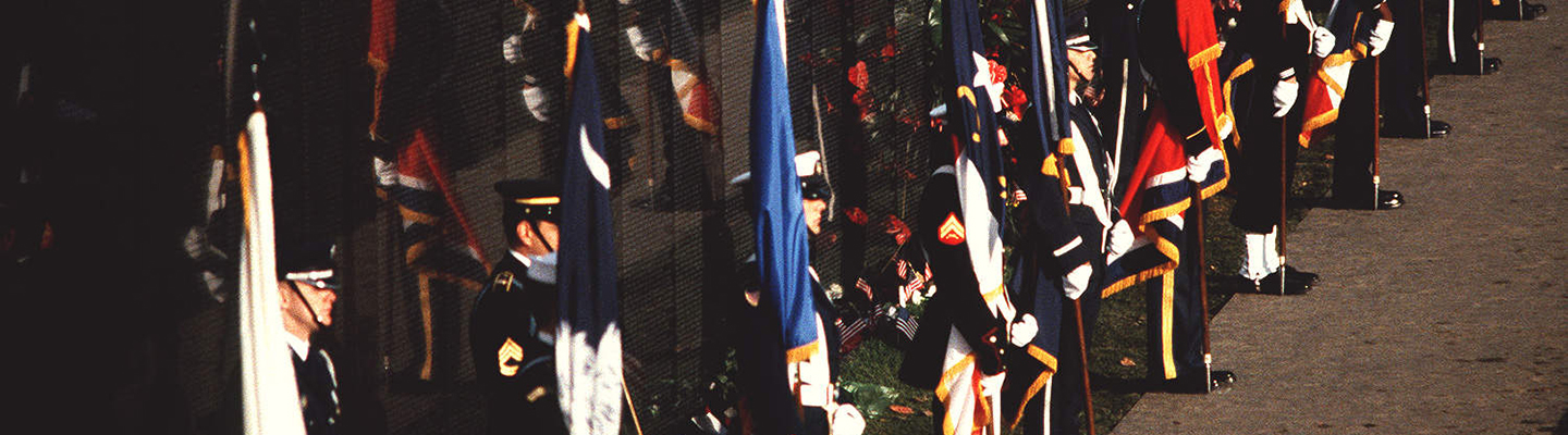 Military honor guards stand with flags at dedication of Vietnam Veterans Memorial dedication in 1982