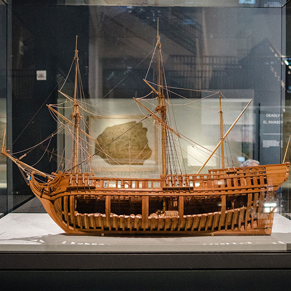 A scale model of the La Belle is on display in front of the ship's preserved and reconstructed hull.