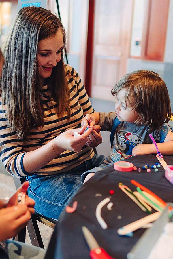 woman and child working on a craft together at the Bullock Museum