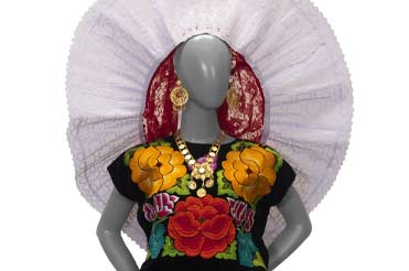 fiesta dress from Oaxaca with a white veil that is in the shape of a halo and frames the face