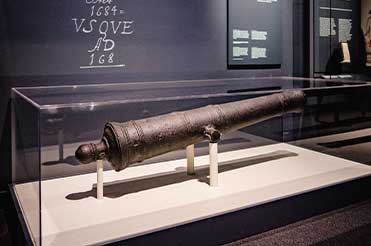 bronze cannon from the ship La Belle on display in the Bullock Museum