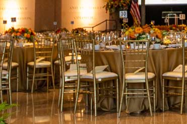 decorative tables and chairs set up in the main lobby of the Bullock Museum for an evening event