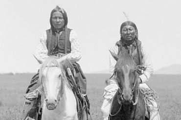Photograph of Comanche people on horseback